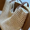 The 2025 new summer woven hollowed-out handbag made of cotton, the same style as the beach bag, is a niche design for women. It is a net bag bag for women Application Scenario